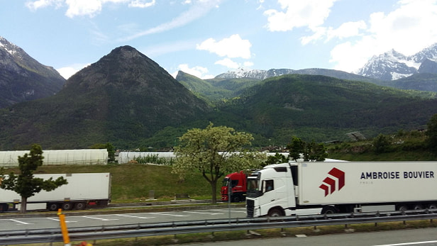 Trucks on the road near Italian Alps